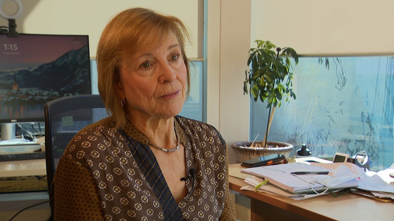 A woman sits at a desk.
