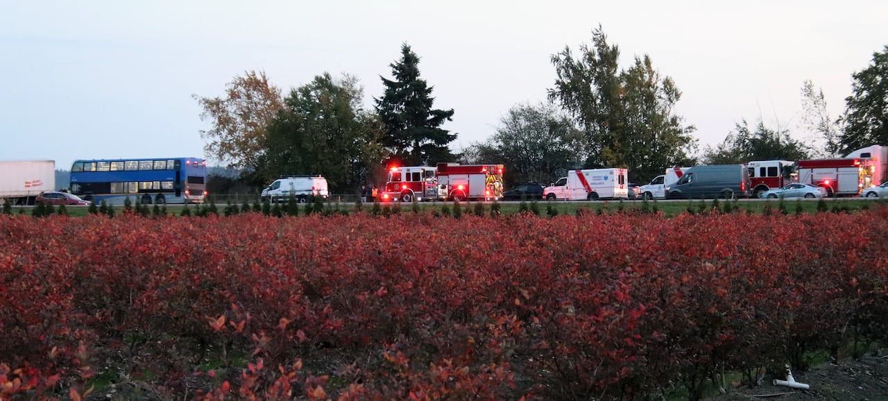 A number of emergency vehicles are seen along a highway.