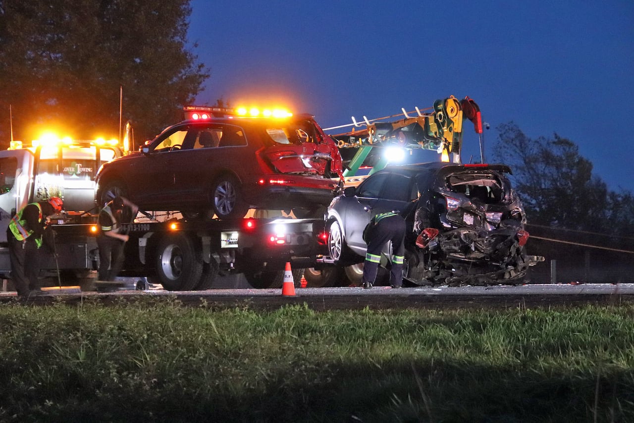 Two smashed up cars are getting towed.