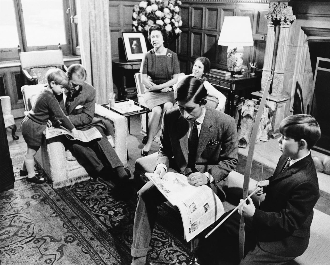 A family sits in a living room.