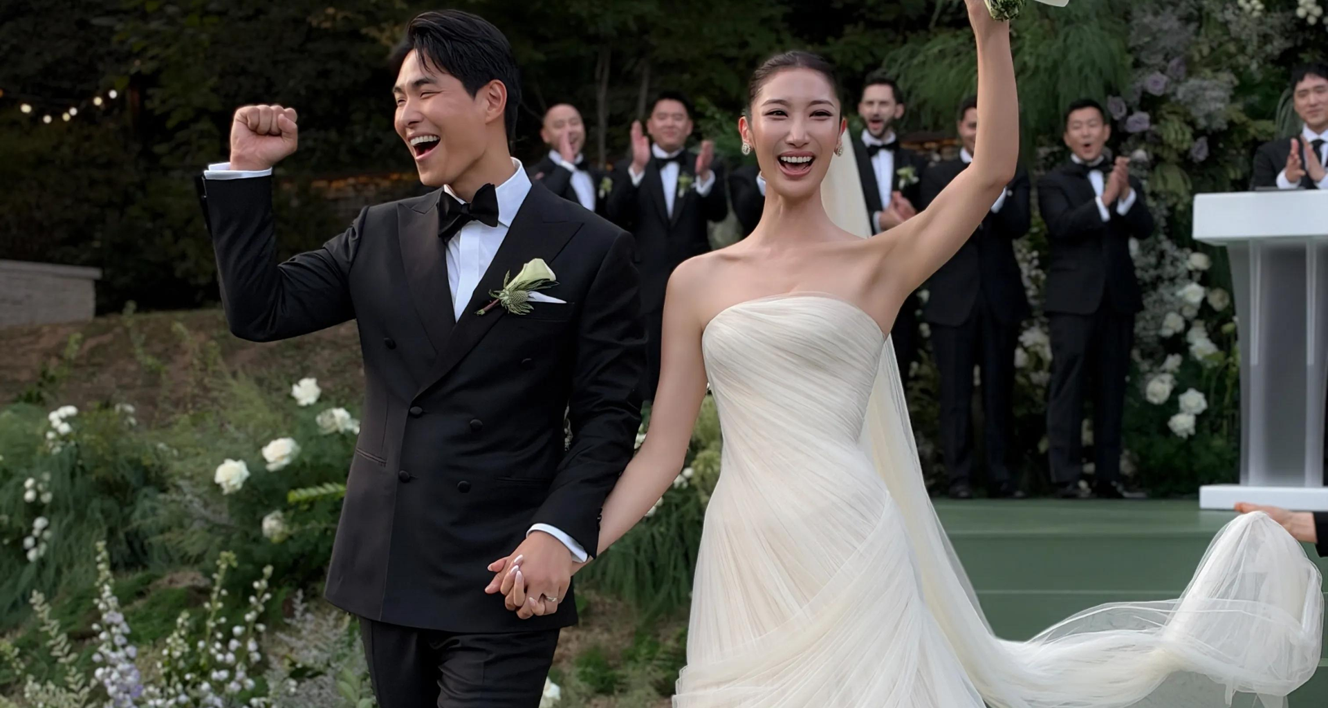 Korean American singer-songwriter EJAE, right, and music producer-composer Sam Kim pose in this wedding photo captured from Vogue