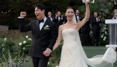 Korean American singer-songwriter EJAE, right, and music producer-composer Sam Kim pose in this wedding photo captured from Vogue
