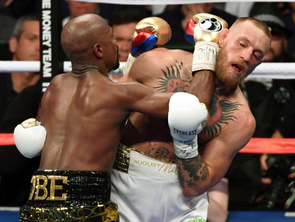 Floyd Mayweather Jr. throws a punch at Conor McGregor in the fifth round of their super welterweight boxing match at T-Mobile Arena on August 26, 2017 in Las Vegas, Nevada.