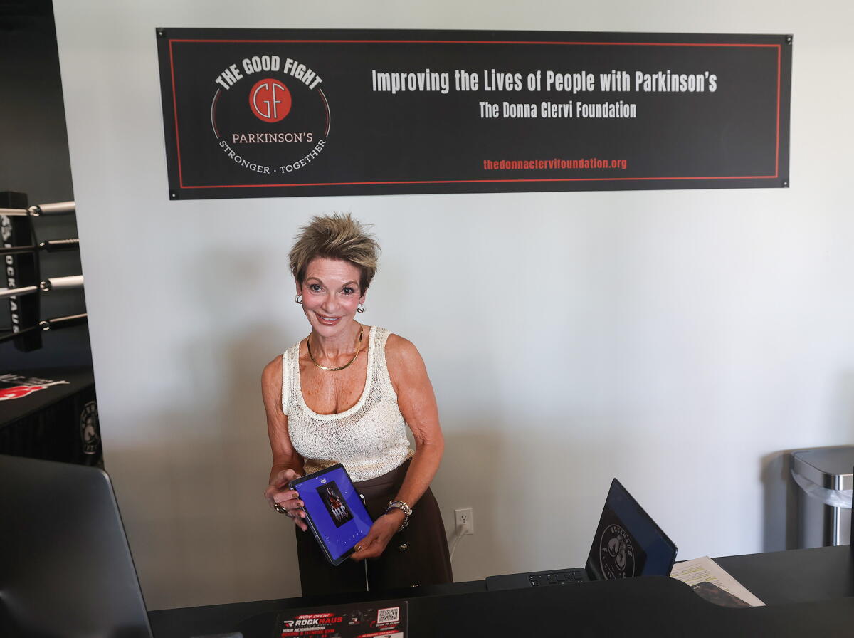The Good Fight Parkinson's founder Donna Clervi stands at the front desk of new Rock Haus Fitness location in Lake Forest.