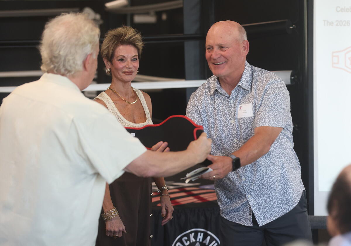 The Good Fight Parkinson's executive Chip Wiseman and founder Donna Clervi, from left, recognize supporter Jerry Denham.