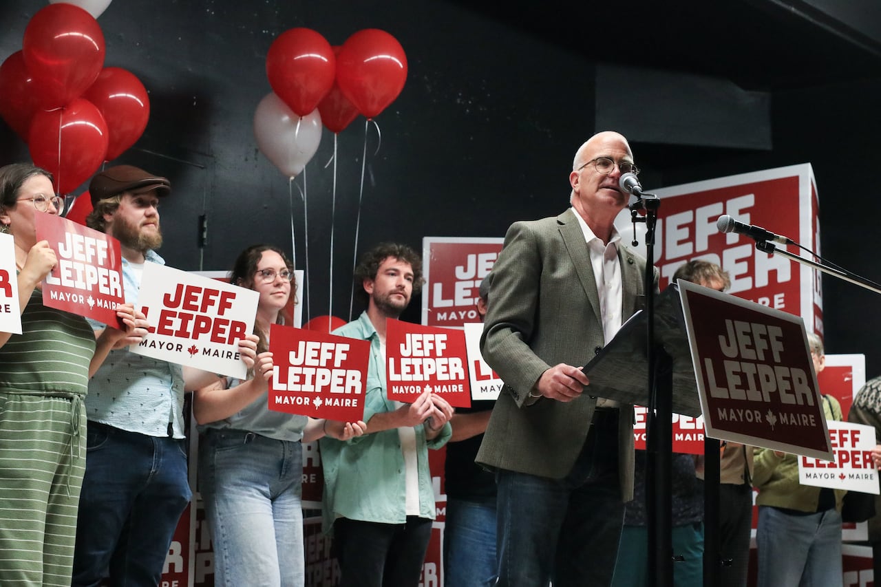 A man at a lectern during a campaign rally.