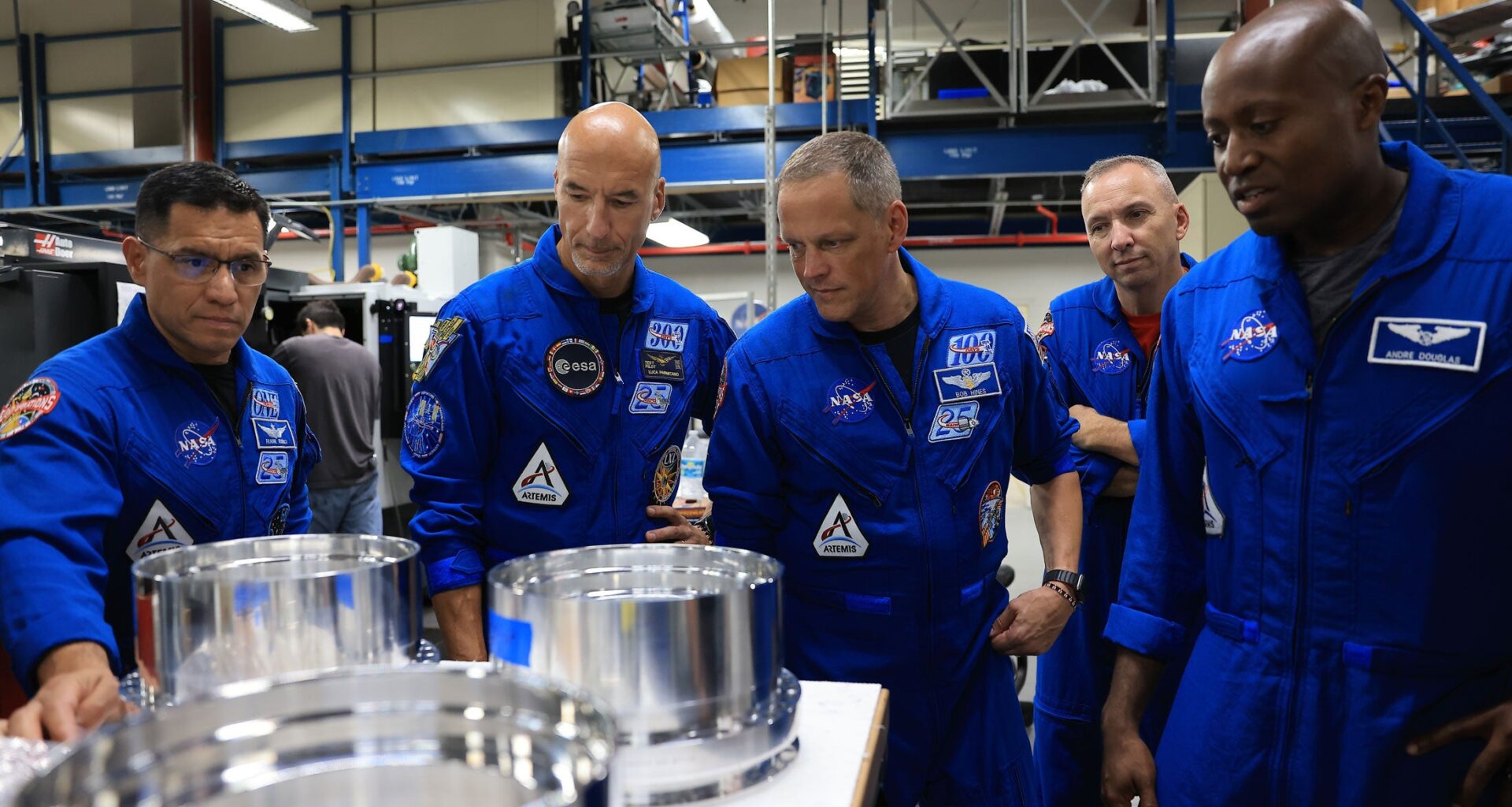 In this photo provided by NASA, from left, NASA astronaut Frank Rubio, ESA (European Space Agency) astronaut Luca Parmitano, and NASA astronauts Bob Hines, Randy Bresnik, and Andre Douglas visit the Prototype Development Laboratory at NASA's Kennedy Space Center in Florida on Wednesday, Sept. 2, 2026.