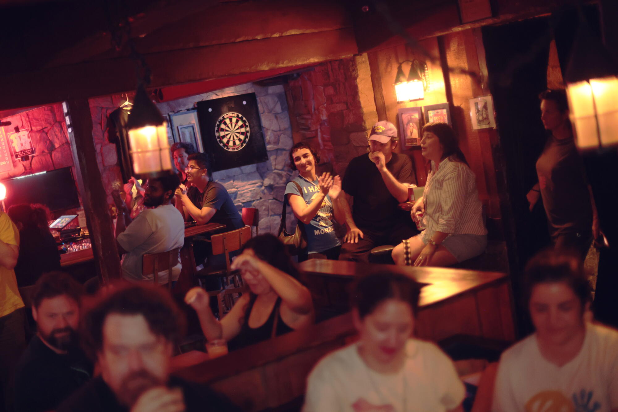 Patrons cheer after a performance during Blue Mondays. Regulars tell stories of forging new friendships at the event.