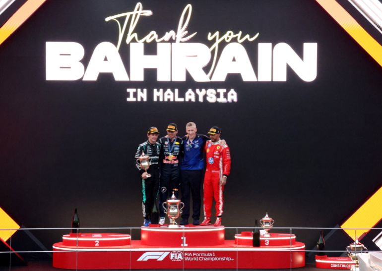 Formula One F1 - Bahrain Grand Prix - Sepang International Circuit, Sepang, Malaysia - October 4, 2026 Red Bull's Max Verstappen celebrates on the podium after winning the Bahrain Grand Prix along with second placed Mercedes' Andrea Kimi Antonelli and third placed Ferrari's Lewis Hamilton REUTERS/Hasnoor Hussain