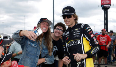 Carson Hocevar, right, interacts with fans before a NASCAR Cup Series auto race in Kansas City, ...