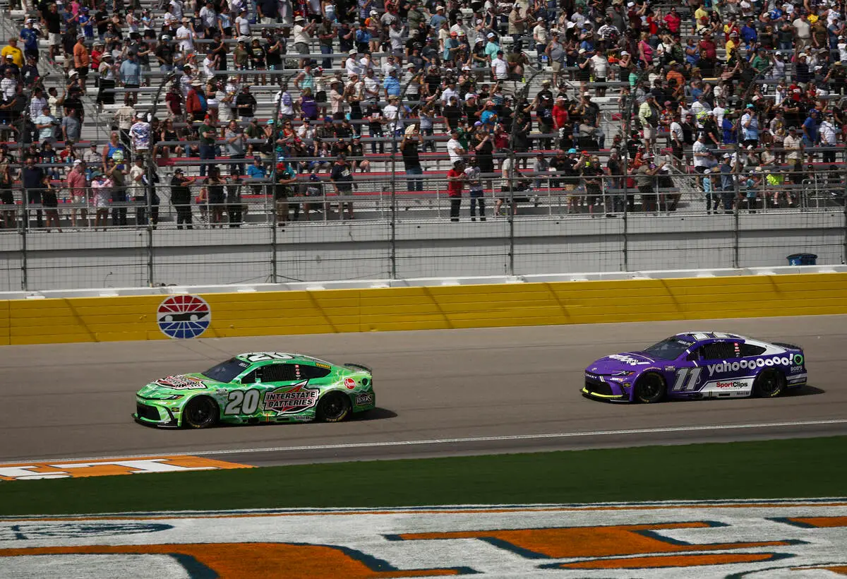 Christopher Bell (20) drives ahead of Denny Hamlin (11) at the start of the Pennzoil 400 NASCAR ...