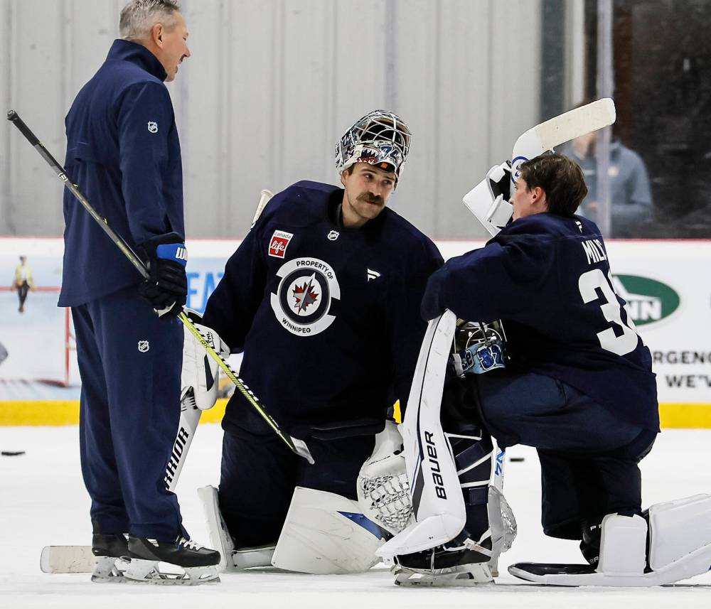 John Woods / THE CANADIAN PRESS FILES
Goaltenders Stuart Skinner (centre) and Thomas Milic (right) chat with Winnipeg Jets goalie coach Wade Flaherty (left) during training camp. The club’s newest goaltender Clay Stevenson is thrilled to work with the “goalie whisperer” Flaherty.