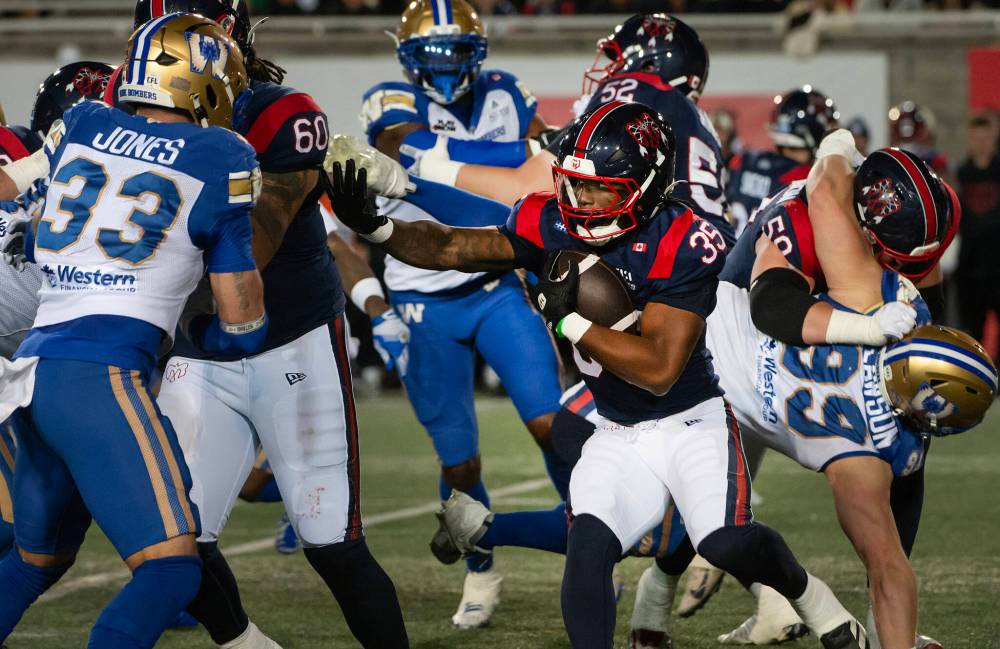 PETER McCABE / THE CANADIAN PRESS
Montreal Alouettes' Shomari Lawrence rushes forward around Winnipeg Blue Bombers' Tony Jones during first half CFL football action in Montreal on Saturday.
