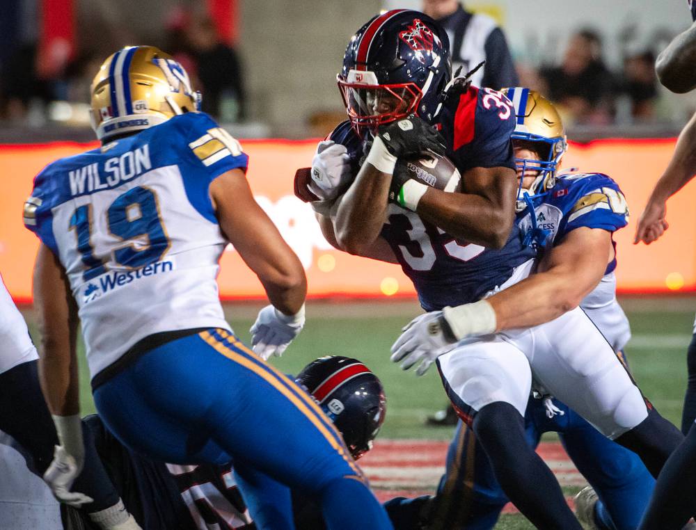 PETER McCABE / THE CANADIAN PRESS
Winnipeg Blue Bombers' Cameron Lawson, back right, tackles Montreal Alouettes' Shomari Lawrence during first half CFL football action in Montreal on Saturday.