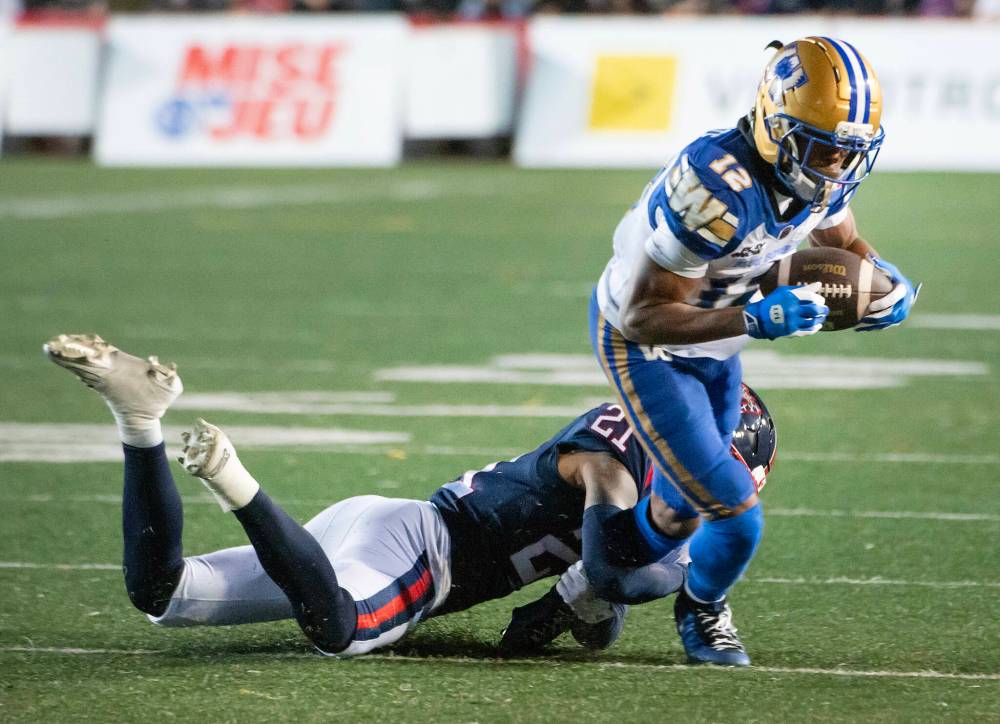 PETER McCABE / THE CANADIAN PRESS
Montreal Alouettes' Don Callis, left, grabs Winnipeg Blue Bombers' Tim White during first half CFL football action in Montreal on Saturday.