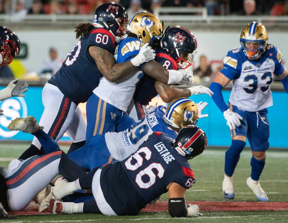 PETER McCABE / THE CANADIAN PRESS
Montreal Alouettes' Stevie Scott (8) charges forward through the Winnipeg Blue Bombers defence during first half CFL football action in Montreal on Saturday.