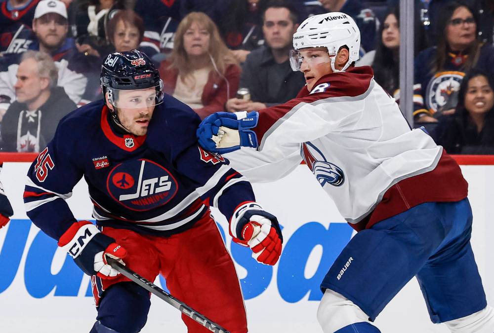 THE CANADIAN PRESS/John Woods
Colorado's Cale Makar tries to slow down Winnipeg's Cole Koepke in the second period.