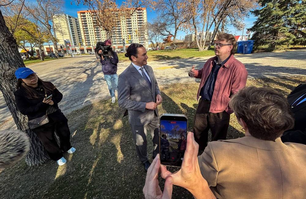 (Mike Deal / Free Press) Premier Wab Kinew chats with Aidan Wilson, a renters advocate, and Transportation and Infrastructure Minister Lisa Naylor, after the press conference.
