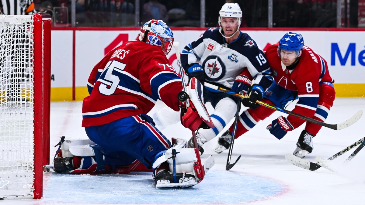 Montreal Canadiens goalie Jakub Dobes (75) makes a save against Winnipeg Jets center Jonathan Toews (19) during overtime at Bell Centre.