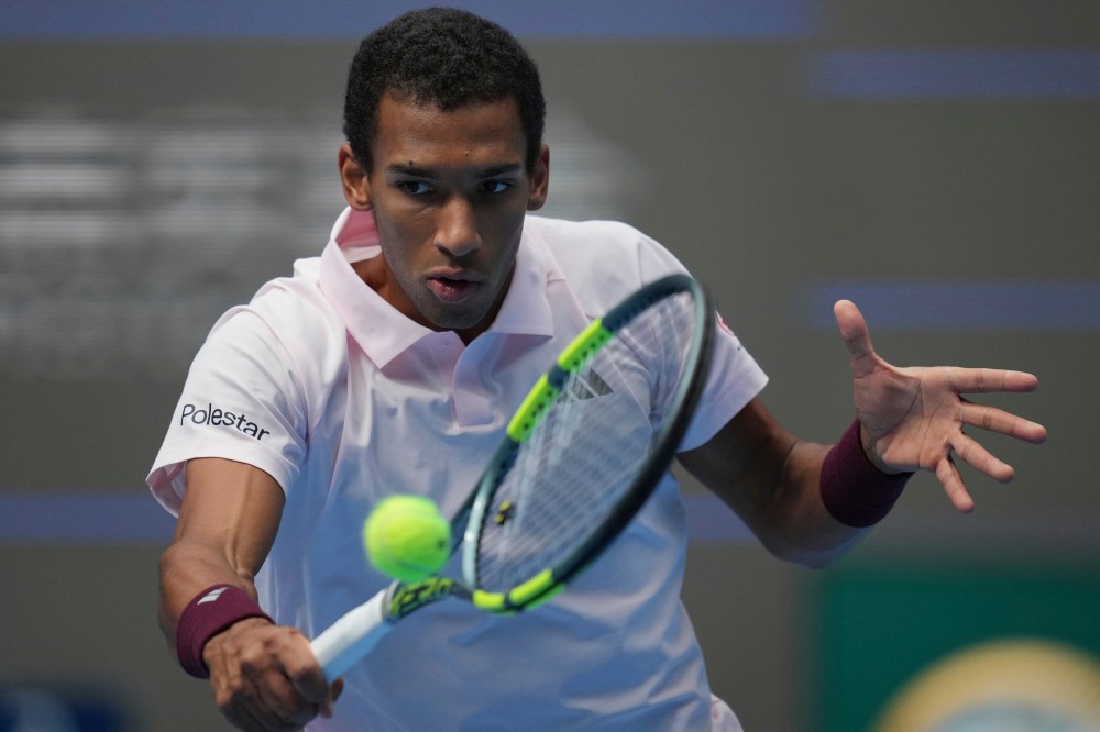 Canada's Felix Auger-Aliassime returns a shot from Russia's Karen Khachanov during their men's singles match of the China Open tennis tournament in Beijing, Wednesday, Sept. 30, 2026. (AP Photo/Achmad Ibrahim)