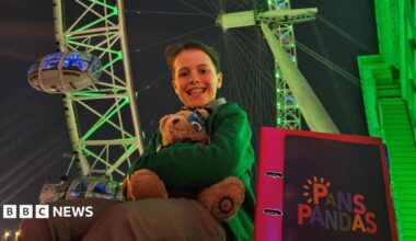 Albie is sat next to a folder saying PANS/PANDAS. Behind hims the green London eye.