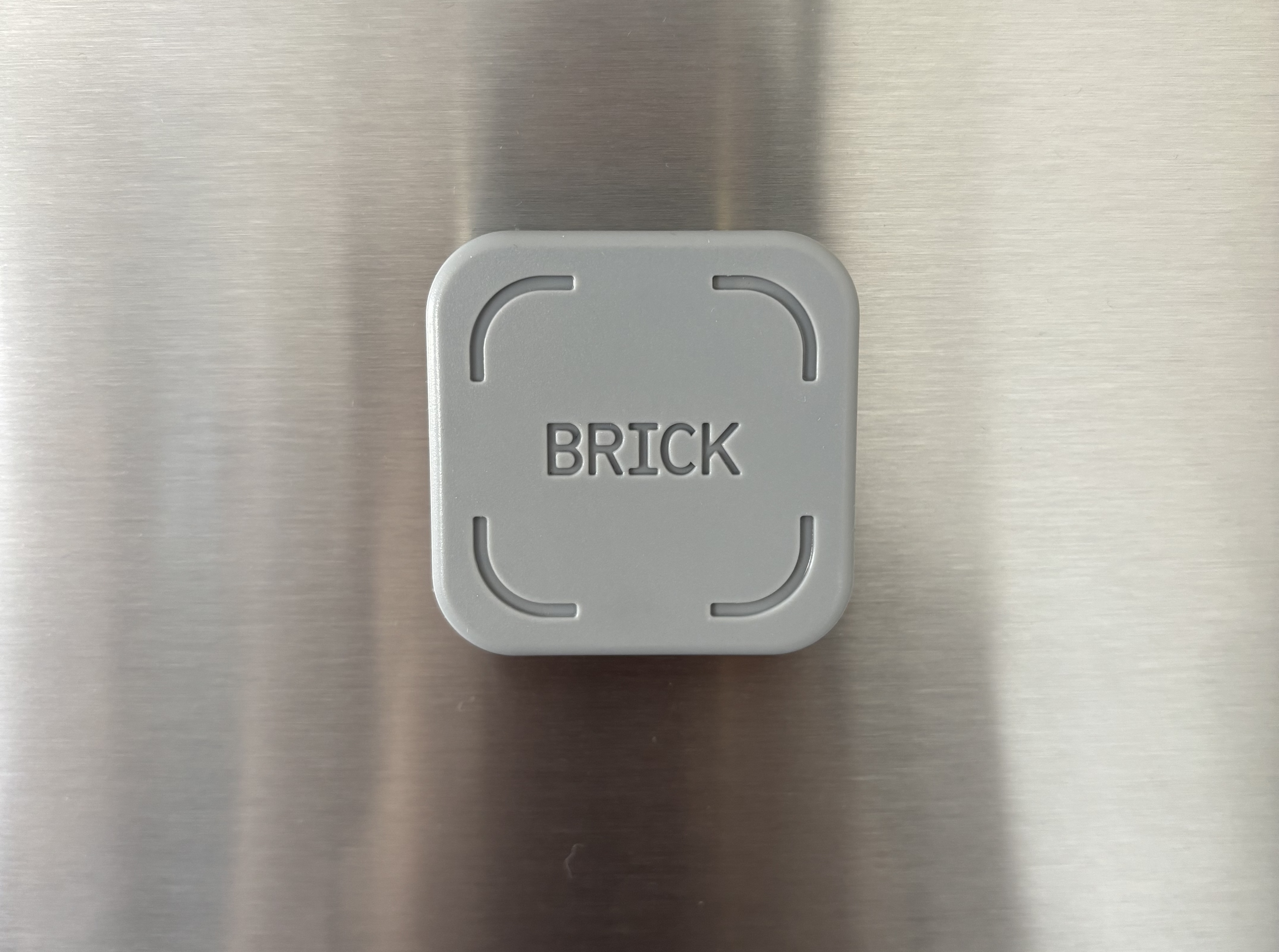 The Brick magnet on a stainless steel fridge.