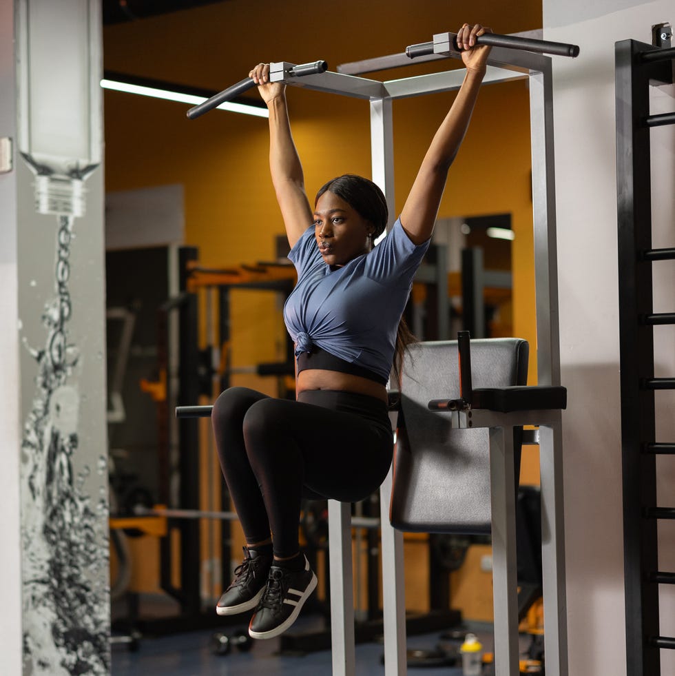 Beautiful black woman working out on fitness exercise equipment at gym Beautiful black woman working out on fitness exercise equipment at gym