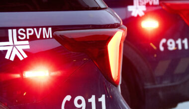 Montreal police cars with flashing red lights.
