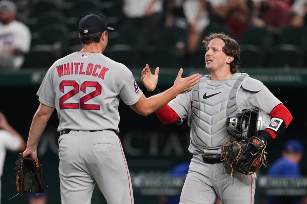 Boston Red Sox pitcher Garrett Whitlock, left, and catcher Adley Rutschman celebrate the team's win in a baseball game against the Texas Rangers Thursday, Sept. 17, 2026, in Arlington, Texas (AP Photo/Tony Gutierrez)