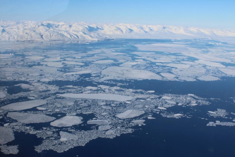 Aerial View of Arctic Sea Ice and Snow Covered Mountains