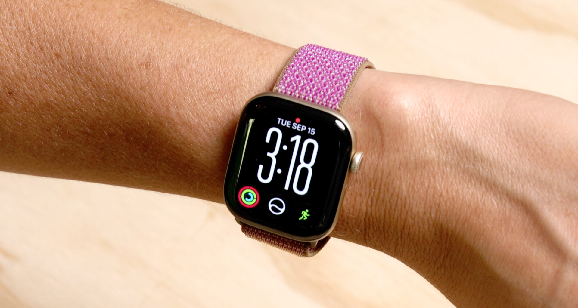 Apple Watch Series 12 with purple band on wrist.