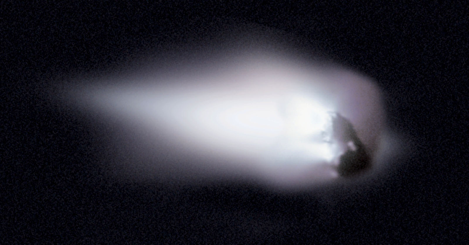 This view of comet Halley's nucleus was obtained by the Halley Multicolour Camera (HMC) on board the Giotto spacecraft, as it passed within 600 km of the comet nucleus on March 13, 1986. a large white coma is visible around a peanut shaped rock.