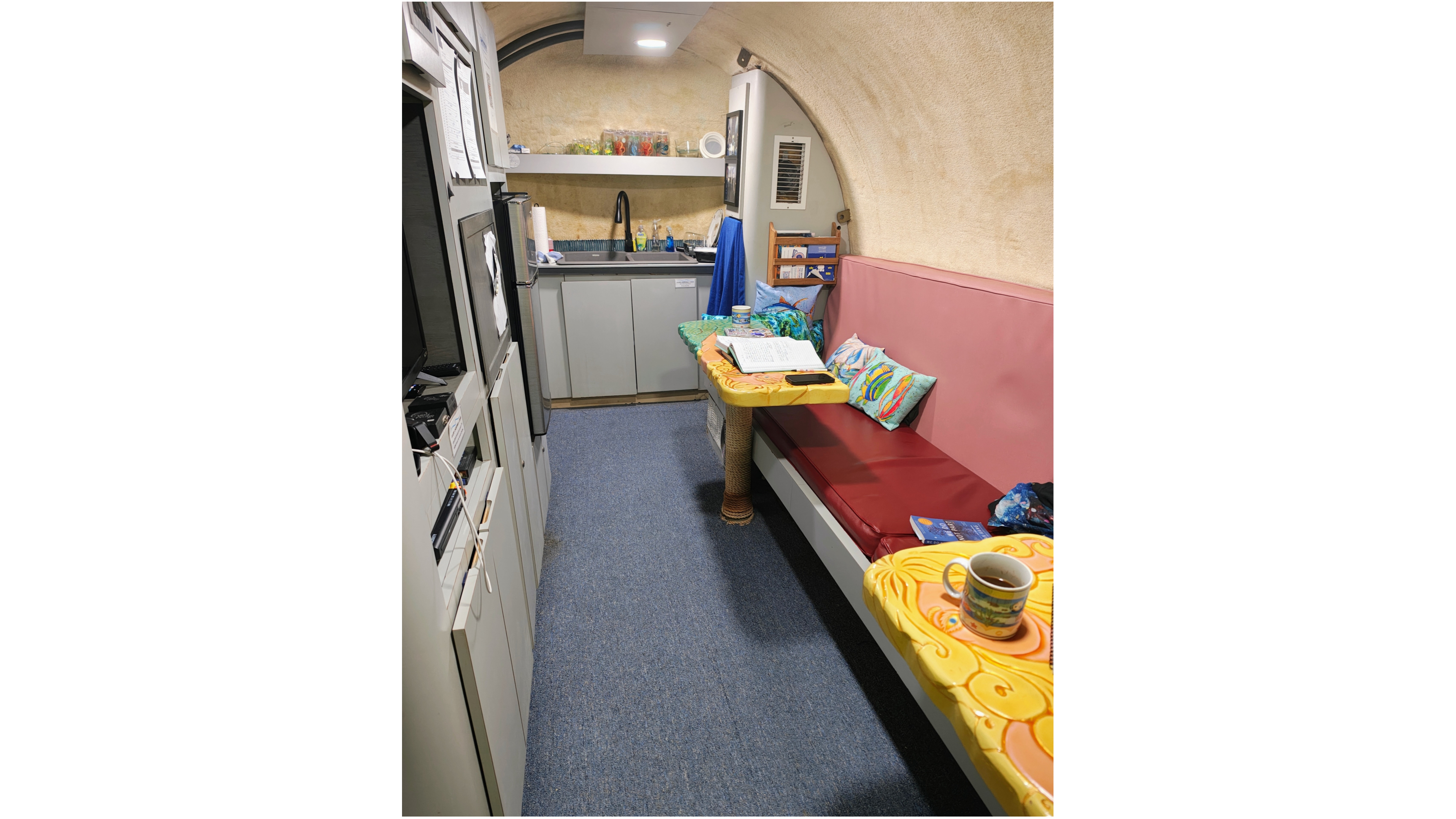 view of a skinny kitchen/eating area inside a research station