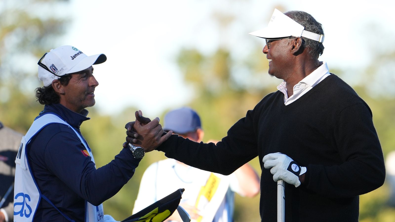 Vijay Singh shakes hands with his caddie