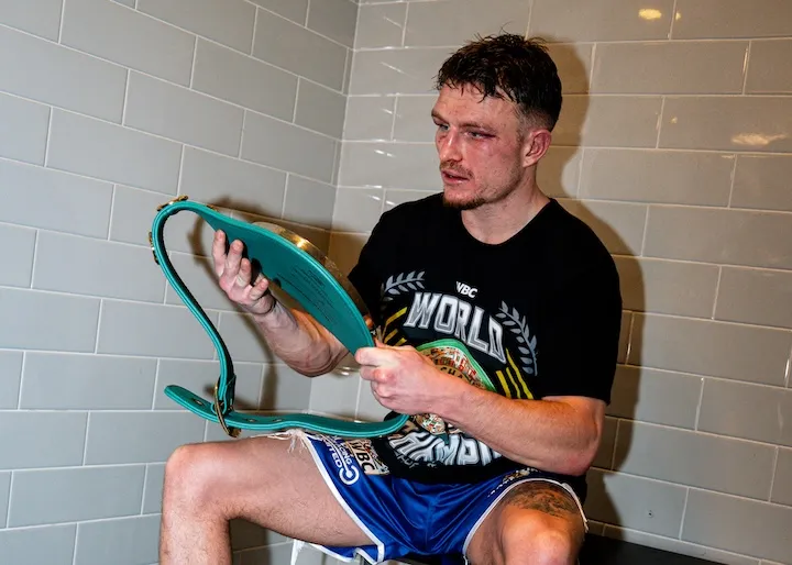 Dalton Smith looks down at the WBC junior welterweight world title soon after knocking out Subriel Matias to win the belt on January 10, 2026.