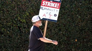BURBANK, CALIFORNIA - AUGUST 16: A WGA (Writers Guild of America) sign reads 'Humanity vs. AI' as striking members picket outside Warner Bros. Studio on August 16, 2023 in Burbank, California. The Writers Guild of America reportedly met with the Alliance of Motion Picture and Television Producers yesterday with a response to the latest offer from the Hollywood studios over a collective bargaining agreement. (Photo by Mario Tama/Getty Images)
