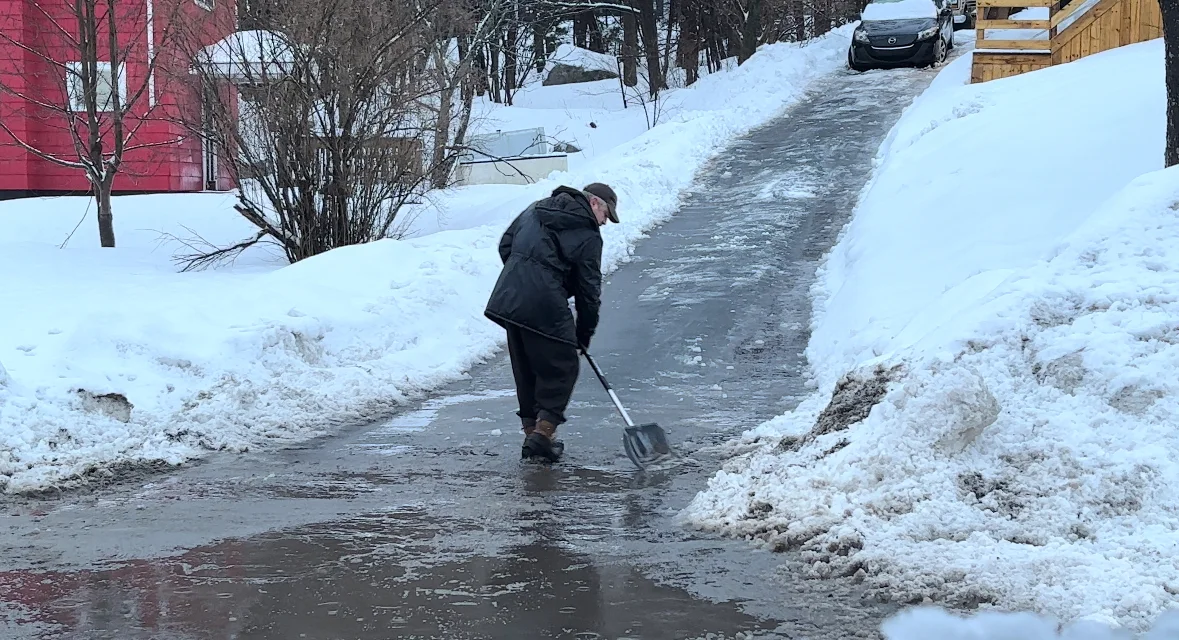 Man shovelling slush and snow in Halifax, N.S. (Nate Coleman/TWN)