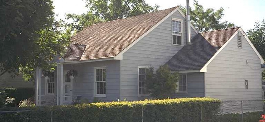 A single-storey home with grey siding and white trim.
