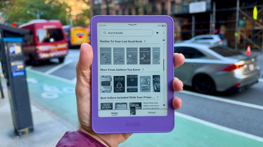 Close of the base Kindle in ube color held in the reviewer's hand in the streets of New York.