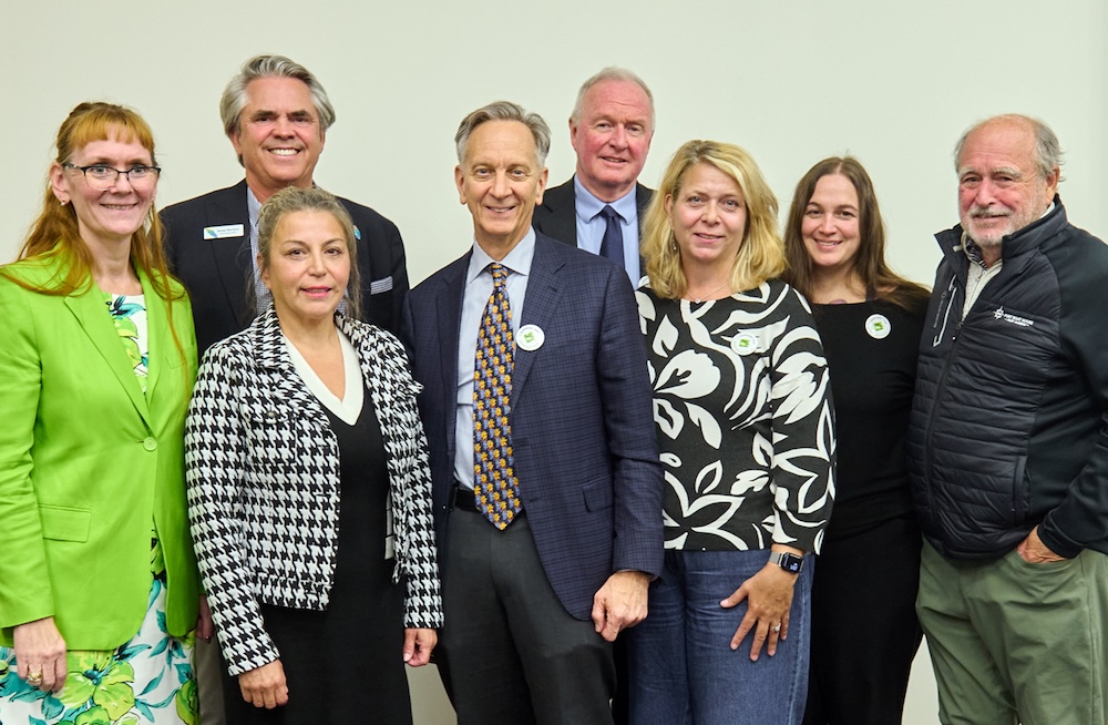 A group photo featuring eight people.