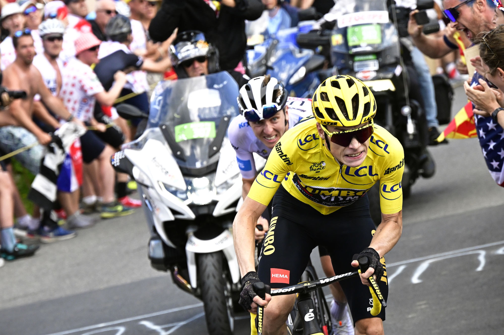 MORZINE LES PORTES DU SOLEIL, FRANCE - JULY 15: (L-R) Tadej Pogacar of Slovenia and UAE Team Emirates - White best young jersey and Jonas Vingegaard of Denmark and Team Jumbo-Visma - Yellow leader jersey compete in the breakaway while fans cheers during the stage fourteen of the 110th Tour de France 2023 a 151.8km stage from Annemasse to Morzine les Portes du Soleil / #UCIWT / on July 15, 2023 in Morzine les Portes du Soleil, France. (Photo by Bernard Papon - Pool/Getty Images)