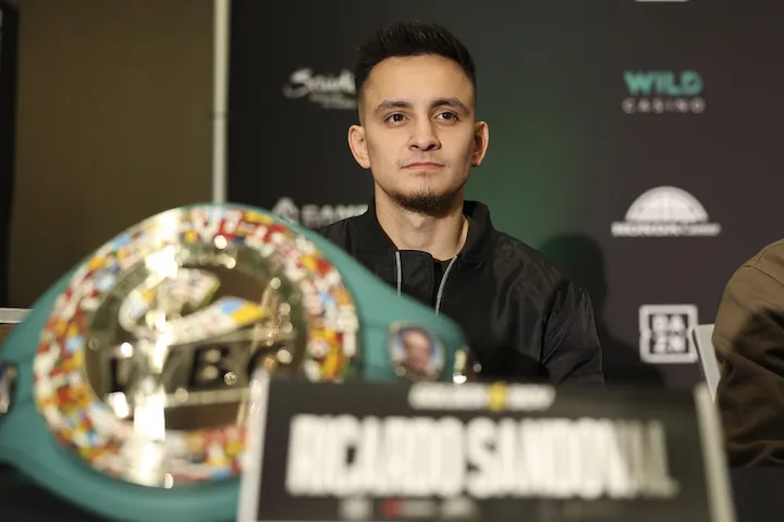 Ricardo Sandoval is pictured with a world title at a press conference.