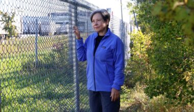Patricia Dutchak, chair of the Transcona Rotary Club’s parks committee, stands next to a chain link fence.