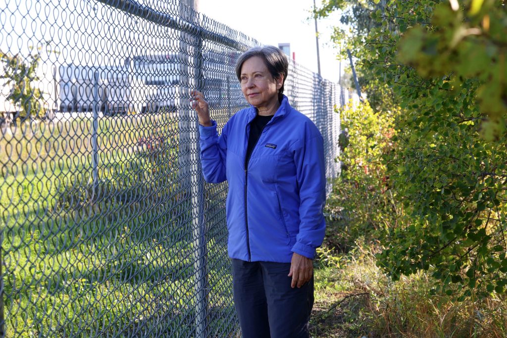 Patricia Dutchak, chair of the Transcona Rotary Club’s parks committee, stands next to a chain link fence.