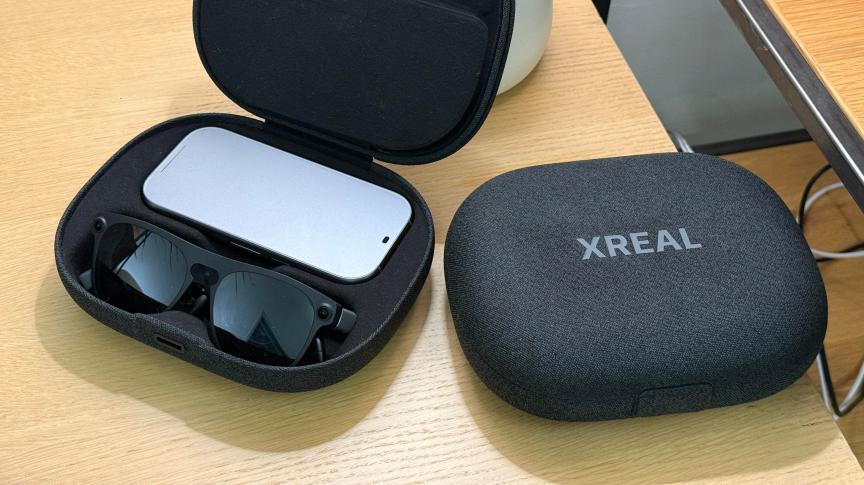 Project Aura glasses and puck in an opened travel case, next to a closed case.