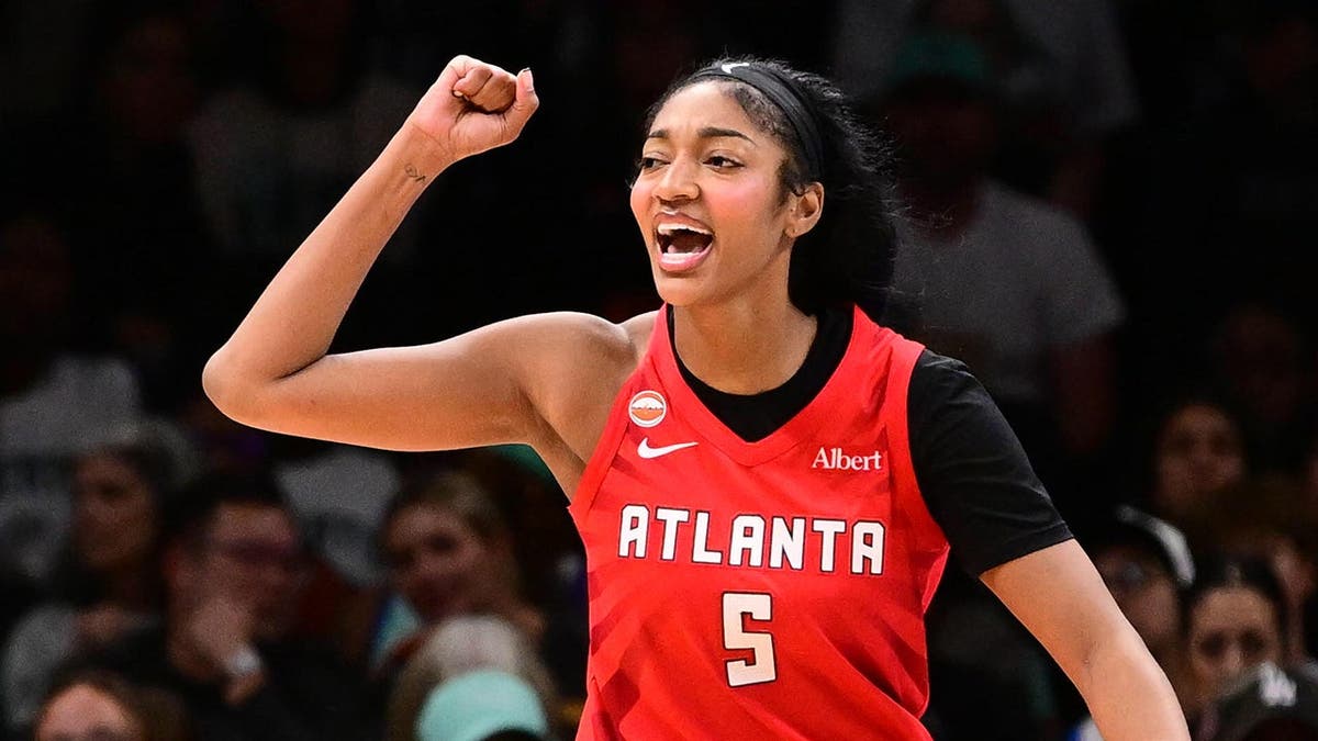 Angel Reese #5 celebrates during a WNBA semifinal game at Barclays Center Arena.