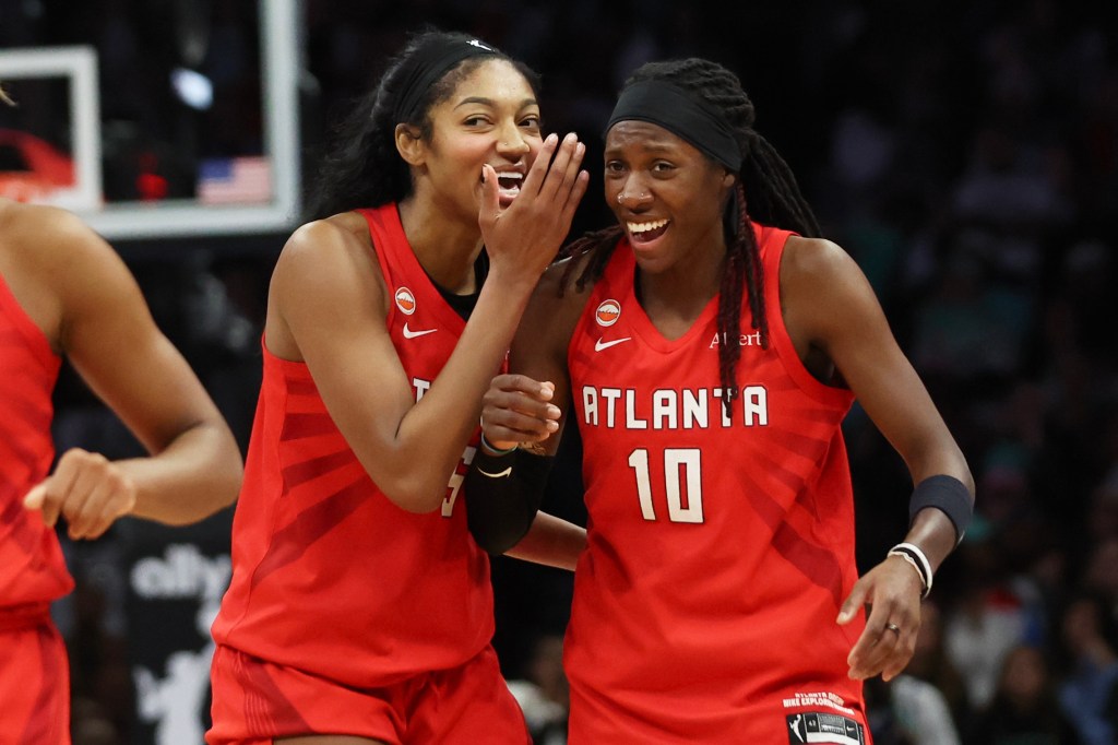 Atlanta Dream forward Angel Reese and guard Rhyne Howard react after defeating the New York Liberty in Game 3 of the WNBA basketball semifinals.