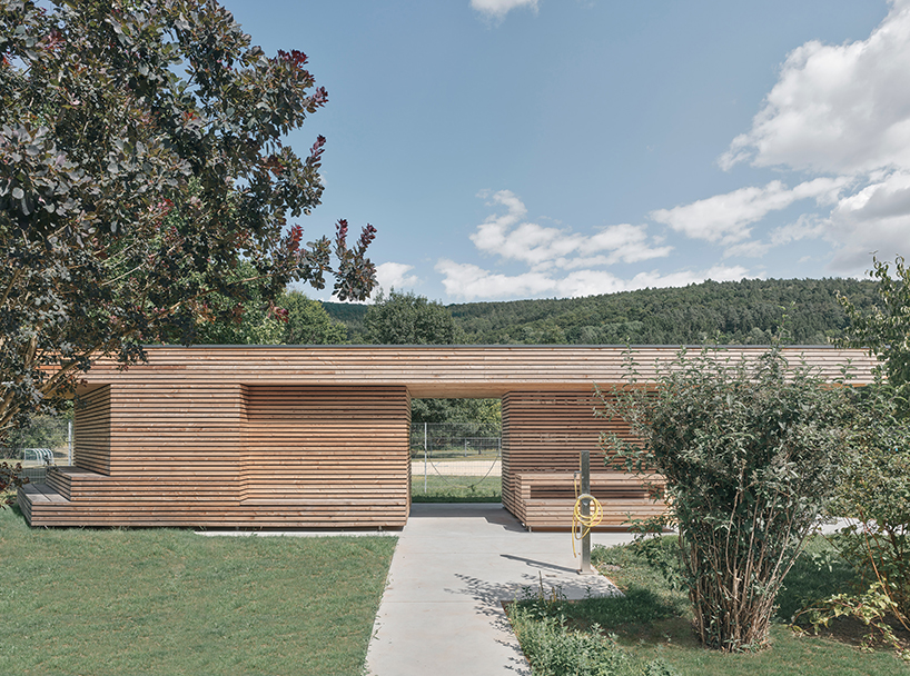 tob.studio’s timber bike station in germany resembles stacked log pile - 2