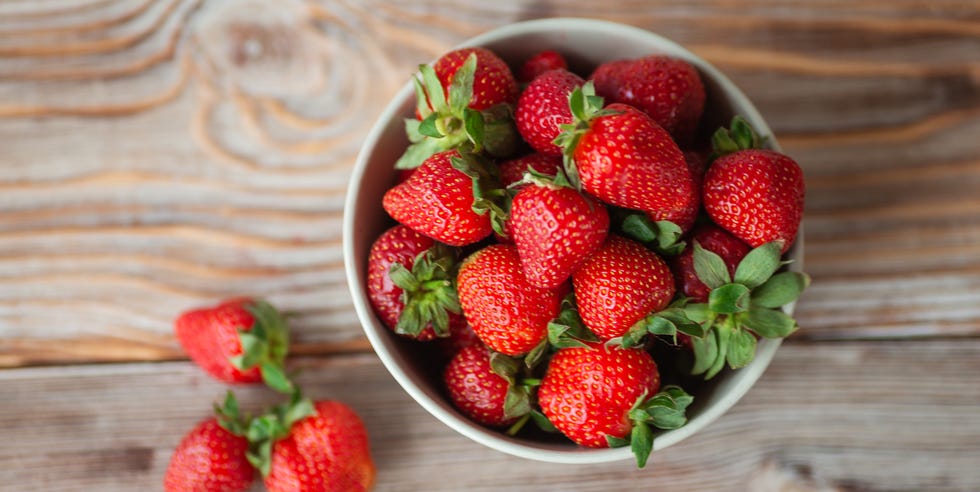 Bowl of ripe strawberries on wooden table - stock photo bowl of ripe strawberries on wooden table stock photo