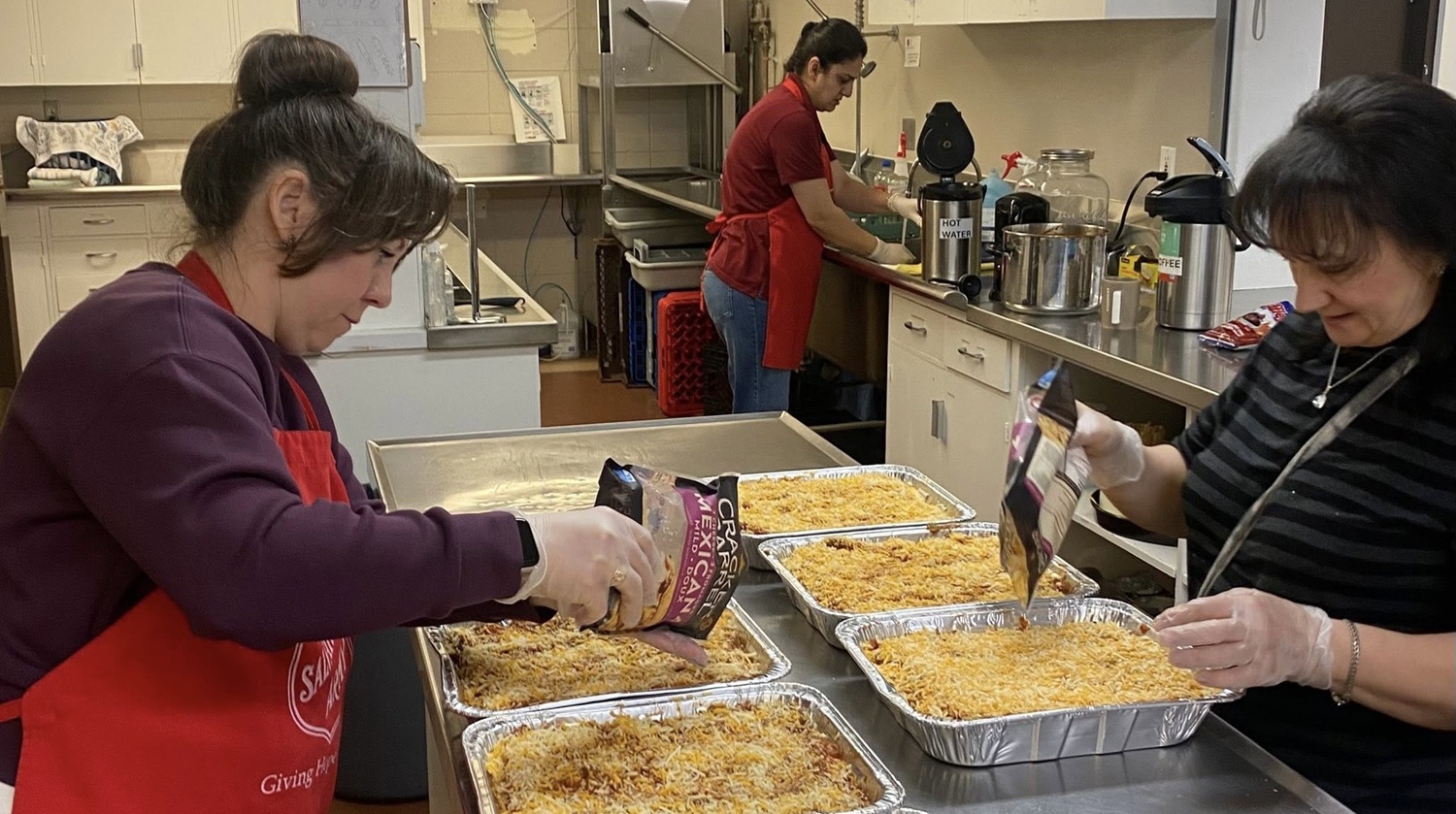 volunteers in kitchen preparing meal